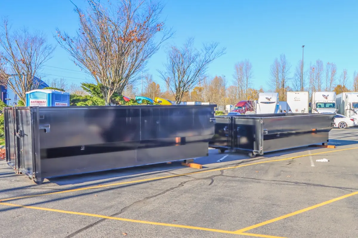 Professional dumpster rental service with roll-off container on residential driveway in Neptune Beach